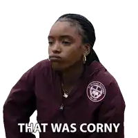 a woman wearing a maroon jacket with the words that was corny on it
