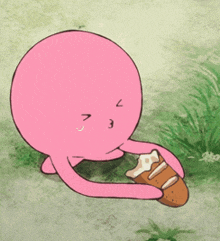 a pink cartoon character is holding a piece of bread in his hand
