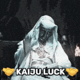 a statue of a man sitting in a chair with the words kaiju luck above him