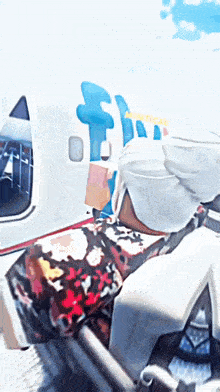 a painting of a person sitting in front of an airplane with the word atlantica on it