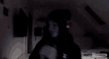 a person wearing headphones with the word kapwing on the bottom right corner
