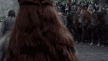 a woman in a fur coat is standing next to a man in a fur coat .