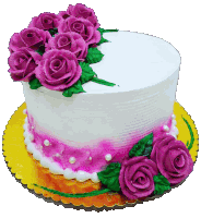 a white cake with pink frosting and purple roses on top