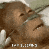 a close up of a monkey wearing an oxygen mask with the words i am sleeping below it