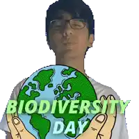a man is holding a globe in his hands with the words biodiversity day written below him