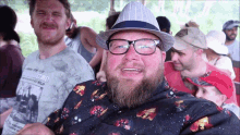 a man wearing glasses and a hat is wearing a shirt that says cowboys travel