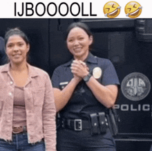 two police officers are posing for a picture in front of a police truck