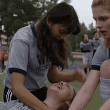 a girl wearing a gray shirt that says yellowfins on it