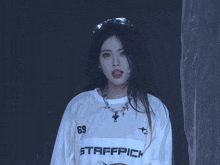 a woman wearing a white shirt that says affrick on it