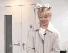 a man wearing a reindeer antlers headband laughs