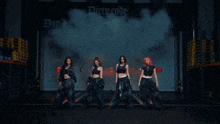 a group of women standing in front of a dirty work logo