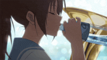 a girl is drinking water from a bottle that has the letter o on it