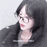a girl wearing glasses and a black jacket with the words solamente de bel written below her