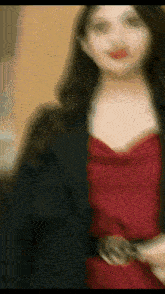a blurry picture of a woman wearing a red dress