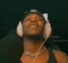 a man wearing a cat ear hat and headphones looks at the camera .