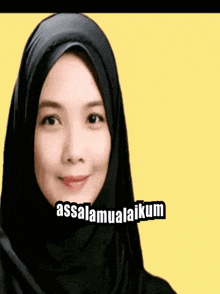 a woman wearing a black hijab with the words assalamualaikum written on it