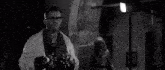 a man and a woman are standing next to each other in a dark room .