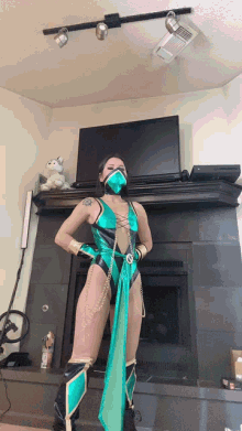 a woman in a costume is standing in front of a fireplace and television
