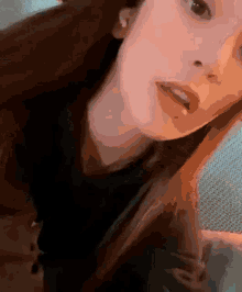 a close up of a woman 's face with her eyes closed