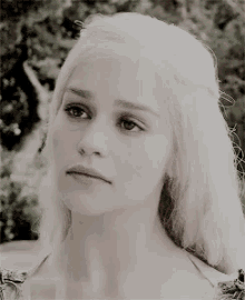 a close up of a woman 's face with blonde hair .