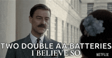 a man in a suit and tie is talking to a woman and saying `` two double aa batteries i believe so ''