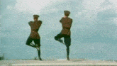 two men in military uniforms are dancing together on a field .