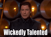 a man in a suit says wickedly talented in front of a bunch of barrels