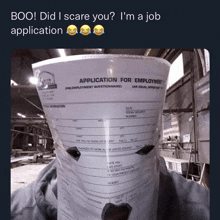 an application for employment form is taped to a cup