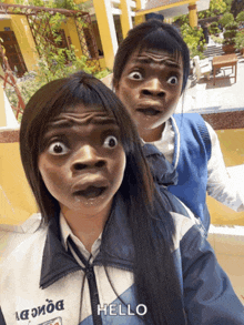 two girls are making funny faces and one of them is wearing a jacket that says dong