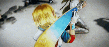 a person is holding a blue and yellow skateboard with a sticker on it that says ' ollie '
