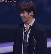 a man in a suit and tie is making a heart shape with his hand and says he hahahahegh in red letters