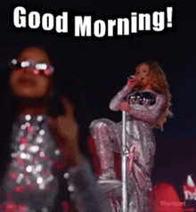 a woman is standing on a pole singing into a microphone while wearing sunglasses .