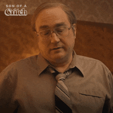 a man with glasses and a tie says " fine "