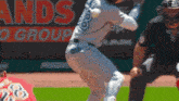 a baseball player wearing number 8 swings at a ball