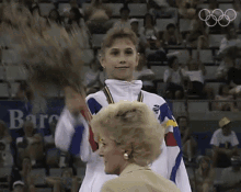 winner lavinia milosovici international olympic committee250days gold medalist waving