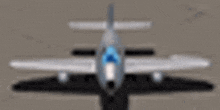 a gray airplane with a blue cockpit is on a runway