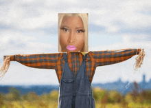 a scarecrow with a picture of nicki minaj on its face