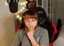 a girl wearing headphones and a cer chair