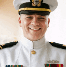 a man in a military uniform is smiling and wearing a hat