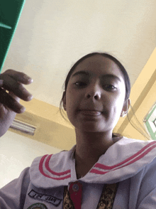 a girl in a school uniform with the name bye n.t.i. on the front
