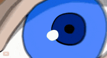 a close up of a person 's blue eye with a white circle in the middle