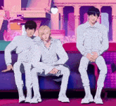 three men are sitting on a couch and one of them has a name tag on his chest that says ' nct dream '