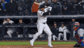 a new york yankees player swings at a pitch
