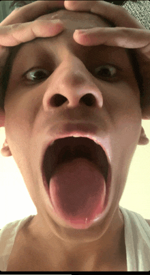 a close up of a person making a funny face with their tongue out