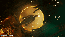 a man with a gun is surrounded by a circle of fire and the name pranay is on the bottom right