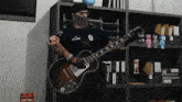 a man playing a guitar with a shirt that says 19 unity