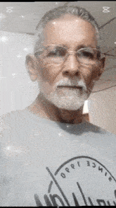 an older man with glasses and a beard is wearing a shirt that says since 1980