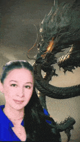 a woman is posing for a picture with a dragon