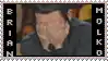 a stamp with a picture of a man covering his face with his hands .