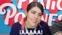 a woman with pink hair is smiling and says iaaaa
